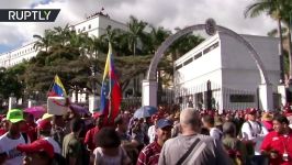 Maduro supporters march through the streets of Caracas with Venezuelan flags