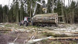 Logging with Valtra A93 forestry tractor large trailer