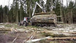 Logging with Valtra A93 forestry tractor large trailer