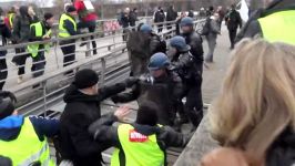 French Rocky Yellow Vest protester boxes group of policemen and walks away