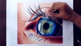 Drawing a realistic eye using colored pencils.