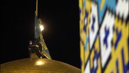 تعویض پرچم گنبد منور رضوی در شب میلاد حضرت رضاع 1399