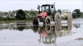 Tractor with Iron Wheels Massey Ferguson 5450 spraying in rice fields