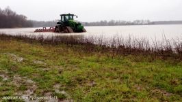 John Deere 8335R on Camoplast CTS track rolling in rice field in Arkansas