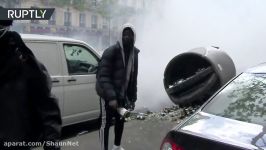 Protesters throw bottles at store fronts in rally against French presidential candidates