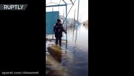 Nothing to see here just 2 men fishing at flooded bus stop in Kazakhstan