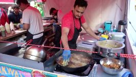 Buying a Pakora Naan Bread Wrap Indian Pakistan Street Food at the Alchemy Festival 2016 London.