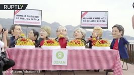 Activists eat spaghetti while imitating G7 leaders to highlight famine crisis