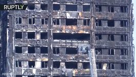 RAW Grenfell Tower still smoldering day after fire kills 17