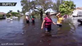 Bonita Springs residents wade home waist deep in water following Irma