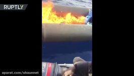 RAW Migrant boat set on fire by Libyan coastguard in Mediterranean