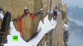 Snow sweepers clear 30cm wide track attached to cliff face in China